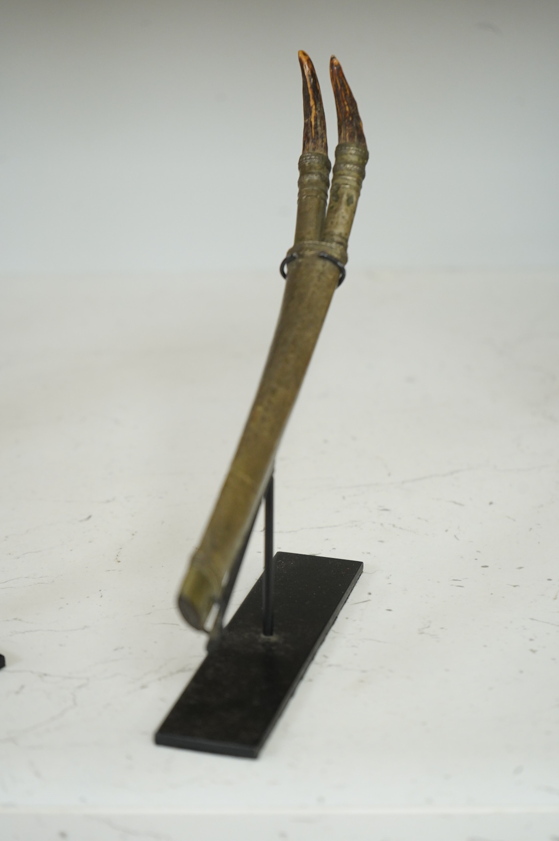 A Burmese dagger dha, blade 14.5cm, hilt and sheath covered in sheet silver filigree decoration, together with an unusual pair of small Burmese knives with silver mounted stag horn handles and silver covered sheath, both